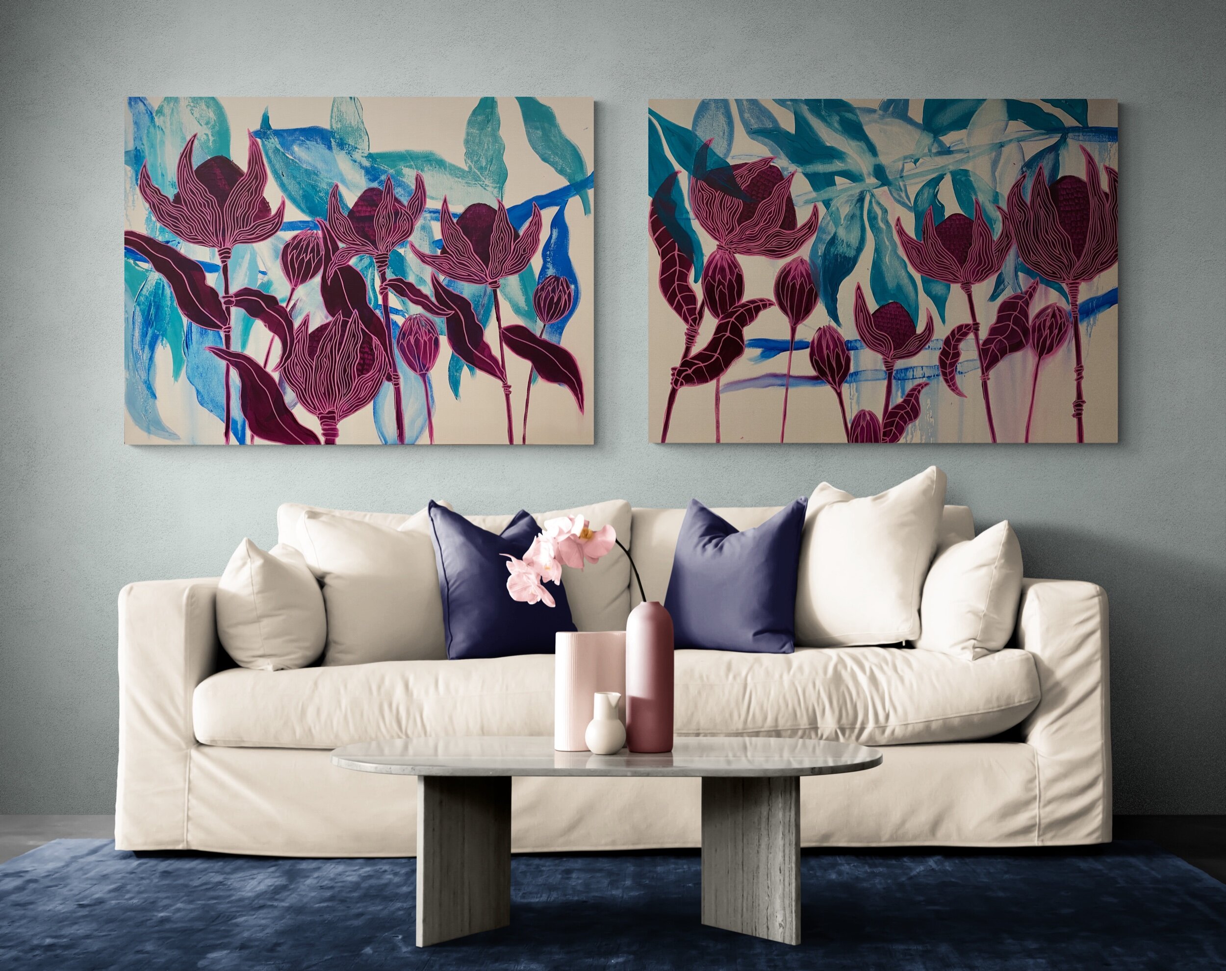 Contemporary living room with a beige couch, colorful floral artwork, and decorative pillows, featuring a modern coffee table and small pink ceramic vases.