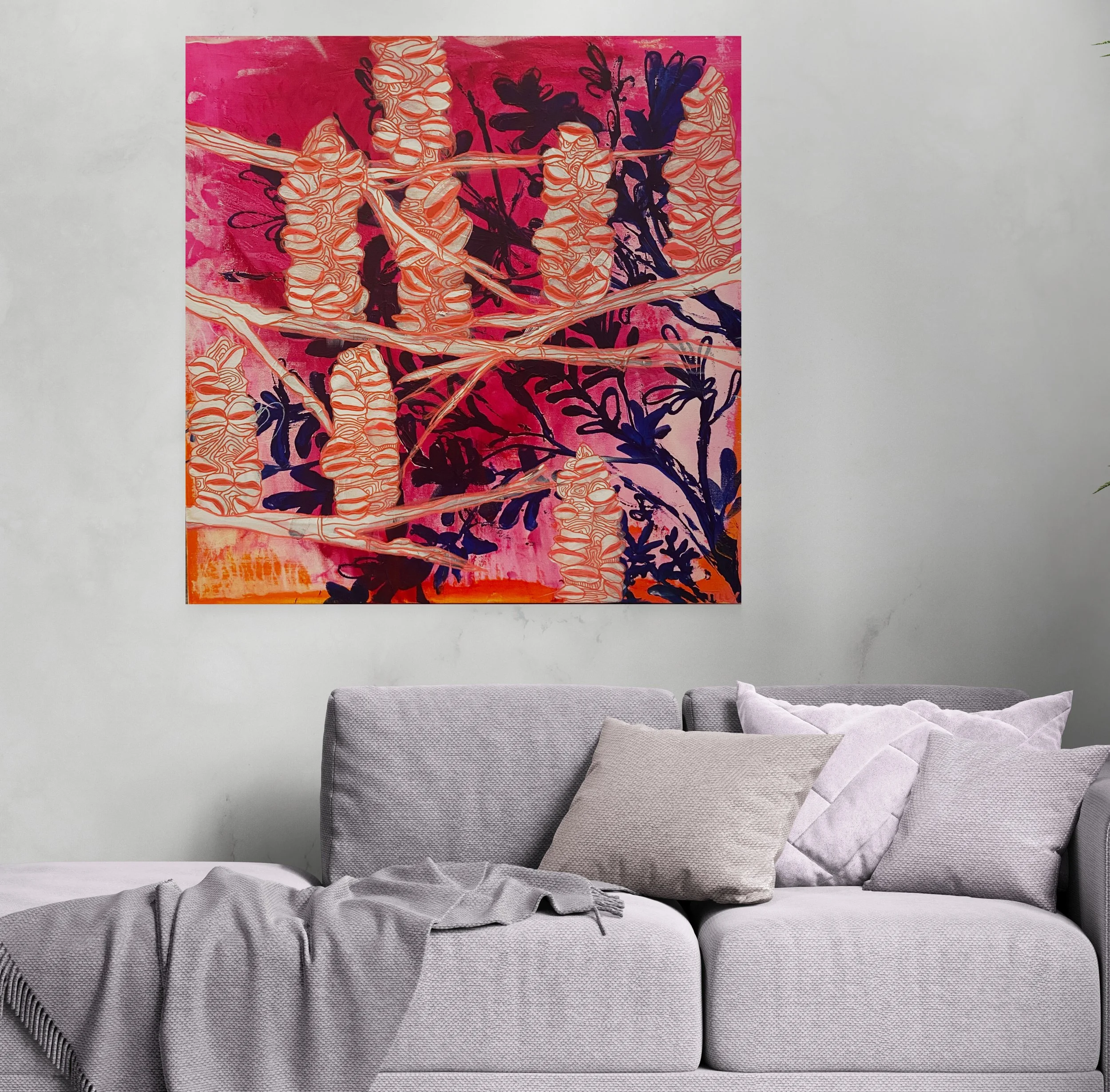 Abstract floral art with pink, orange, and dark colors hanging on a light gray wall above a gray sofa with beige and light purple pillows and a gray throw blanket.
