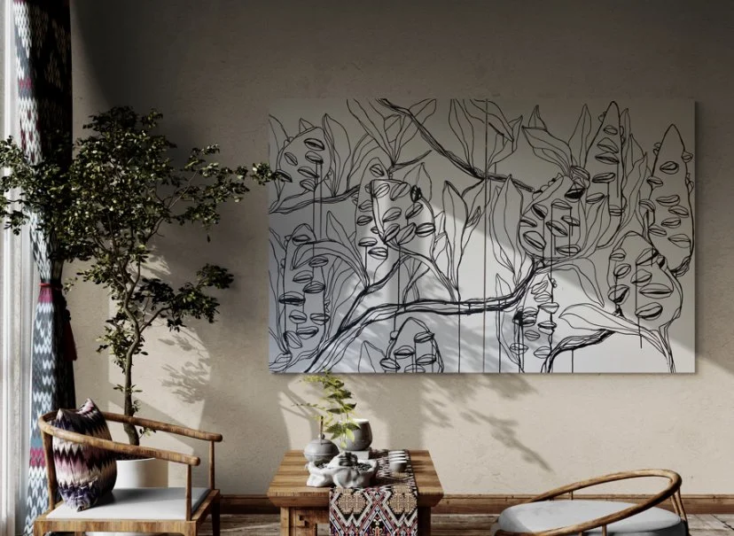 Interior with a large line art painting of leaves on the wall, a wooden table with decorative items, a chair, and a potted tree in the corner.