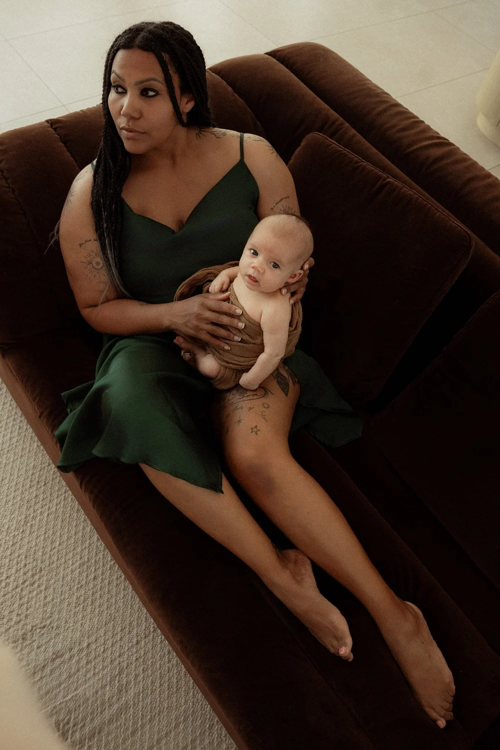 Mother sitting and holding her baby during relaxed motherhood photography session in Perth