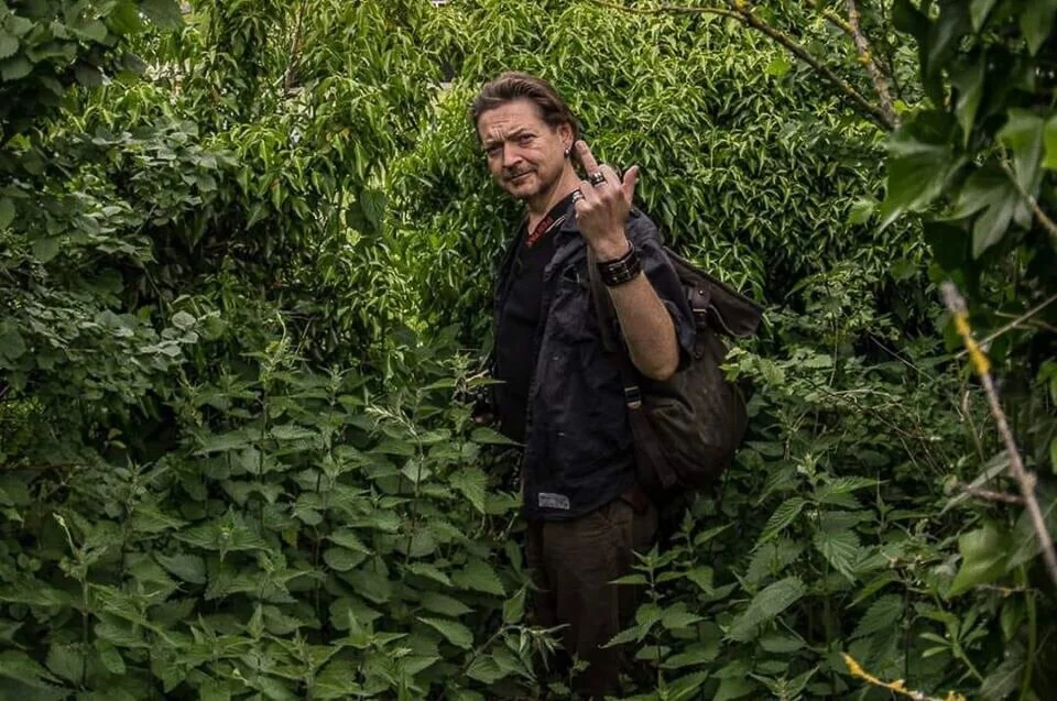 Mike Camp, at the heart of the Watford music scene, standing among tall green plants