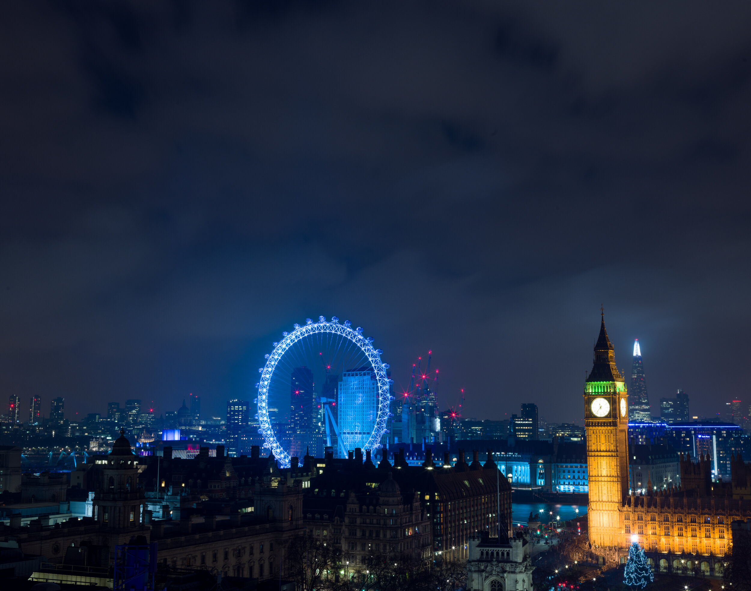 The scene shot for fireworks photography: the London Eye and Elizabeth Tower (Big Ben) lit up at night before the New Year's Eve fireworks begin, taken with a Hasselblad camera