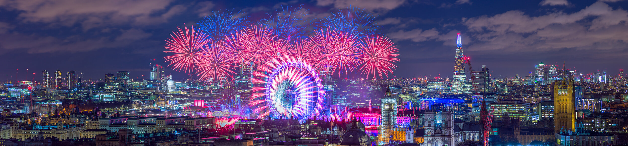 Panorama of London New Year's Eve fireworks over the London Eye, with the Shard and Elizabeth Tower (Big Ben), seen from the roof of Portland House, taken with a Hasselblad camera