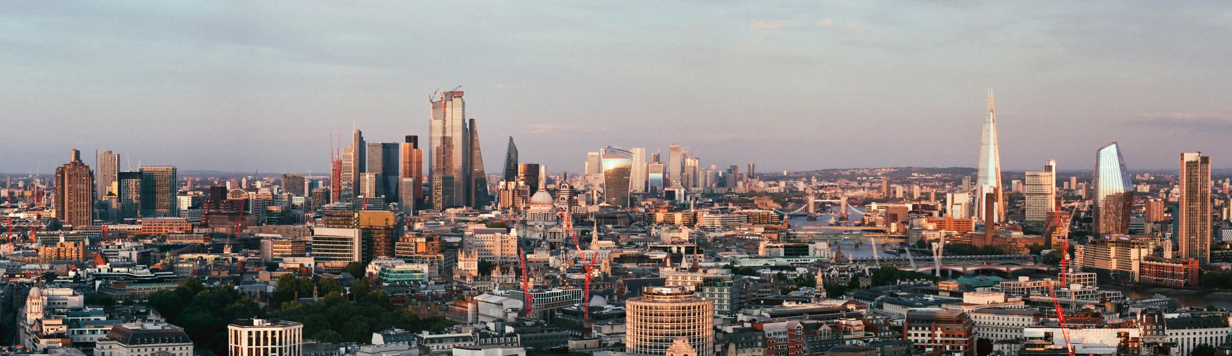 The City of London skyline at dusk, with the Shard and the City towers, seen from the roof of Centre Point, shot on film with a Leica M2