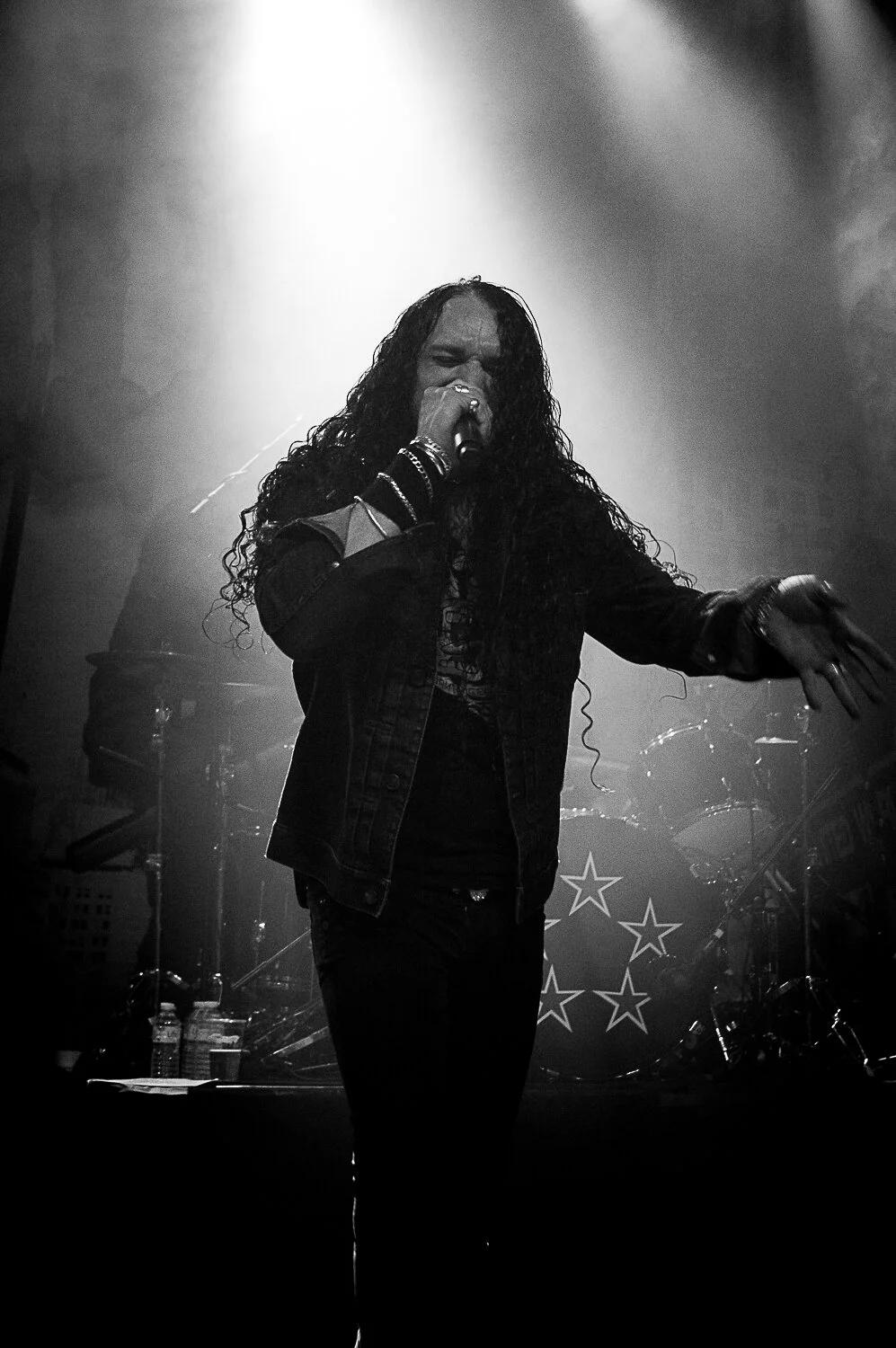ZP Theart singing, backlit on a smoky stage, Skid Row live in concert at The O2 Forum Kentish Town, January 2019