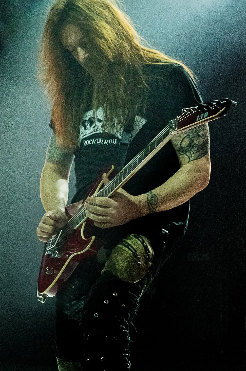 Dave “Snake” Sabo looking down at his red guitar mid-solo, Skid Row live in concert at The O2 Forum Kentish Town, January 2019