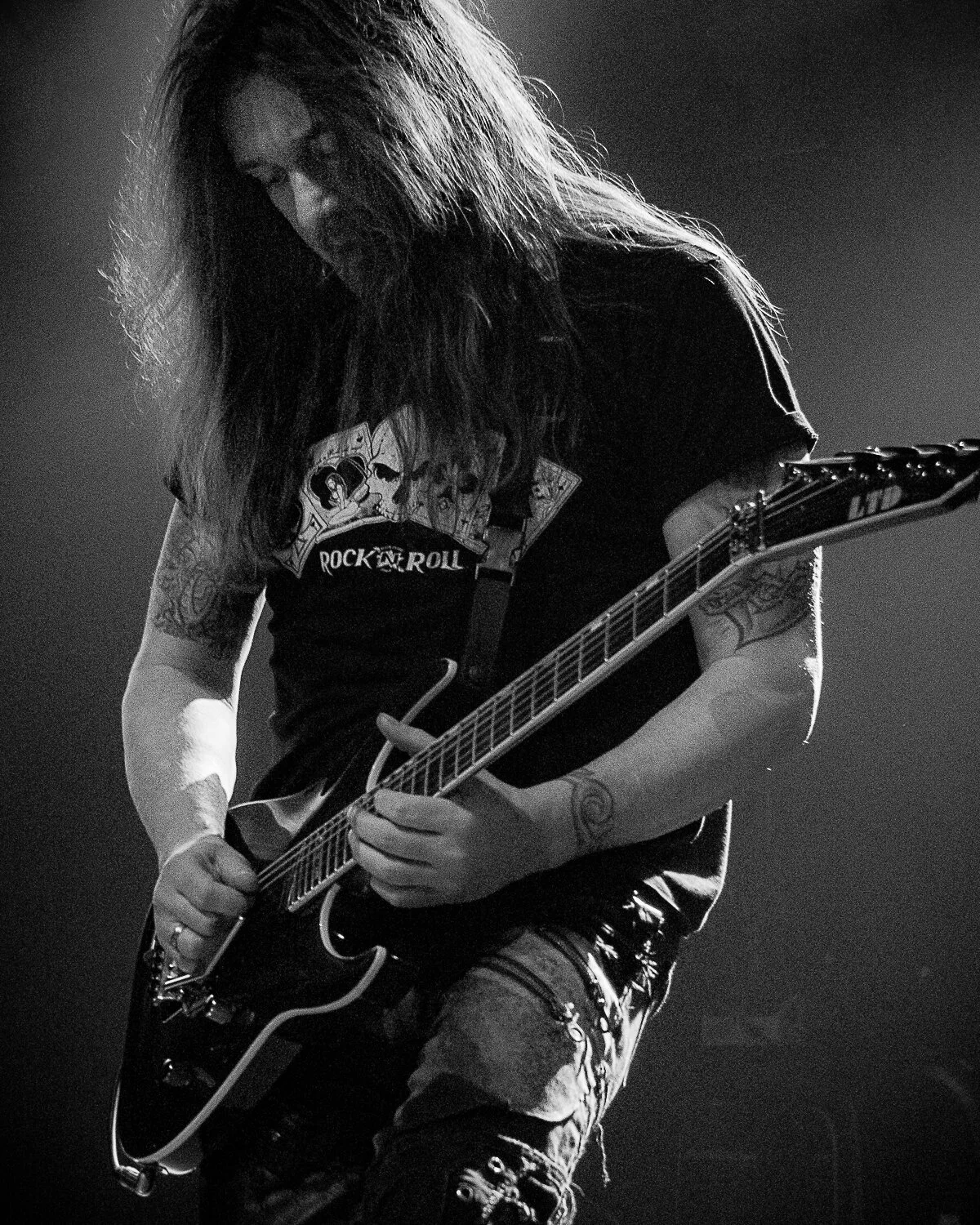Dave “Snake” Sabo playing guitar, hair falling over his face, Skid Row live in concert at The O2 Forum Kentish Town, January 2019