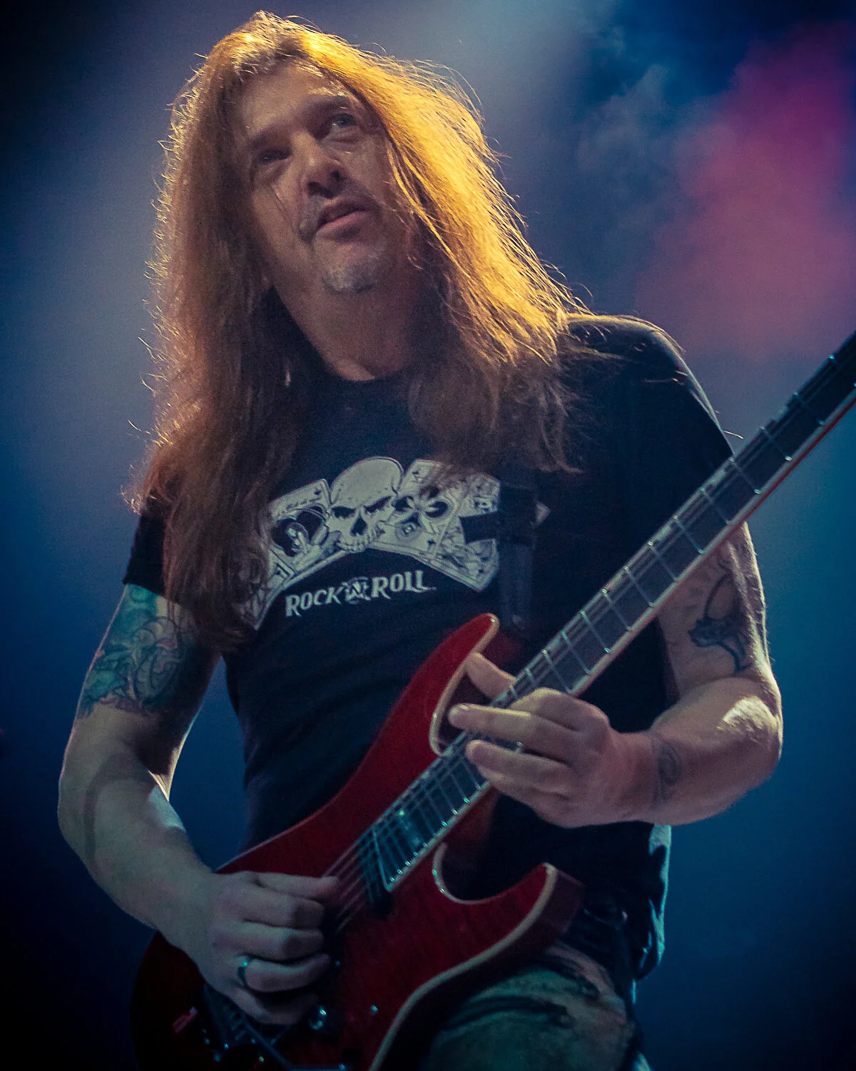 Dave “Snake” Sabo playing a red guitar against blue and pink light, Skid Row live in concert at The O2 Forum Kentish Town, January 2019