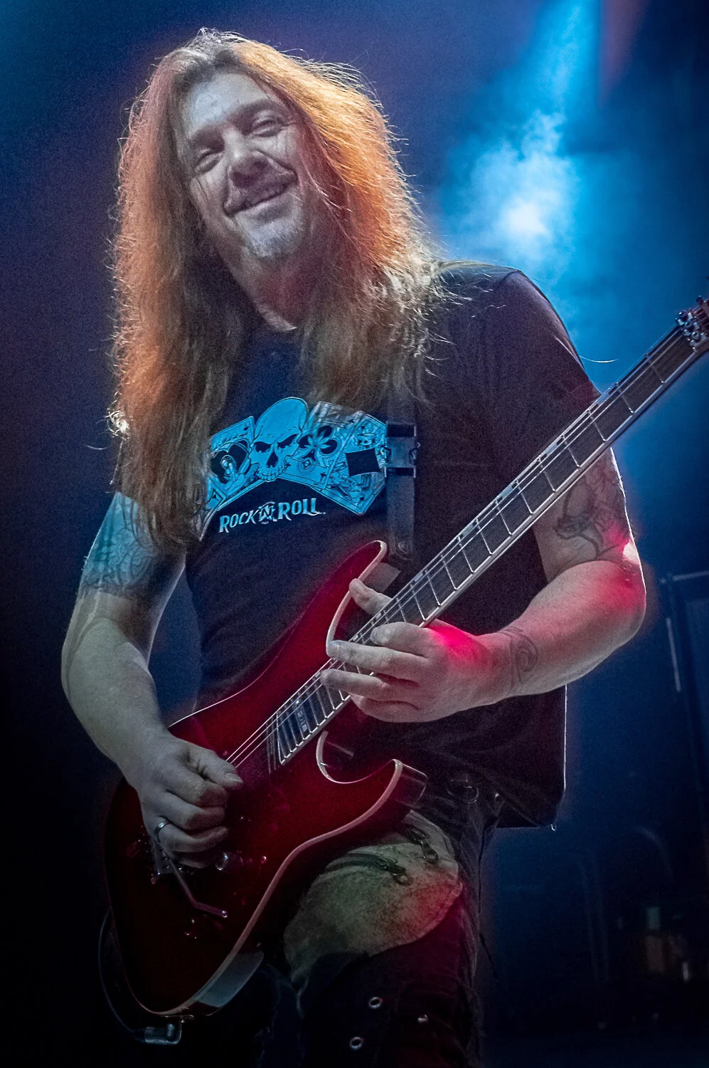 Dave “Snake” Sabo smiling as he plays a red guitar, Skid Row live in concert at The O2 Forum Kentish Town, January 2019