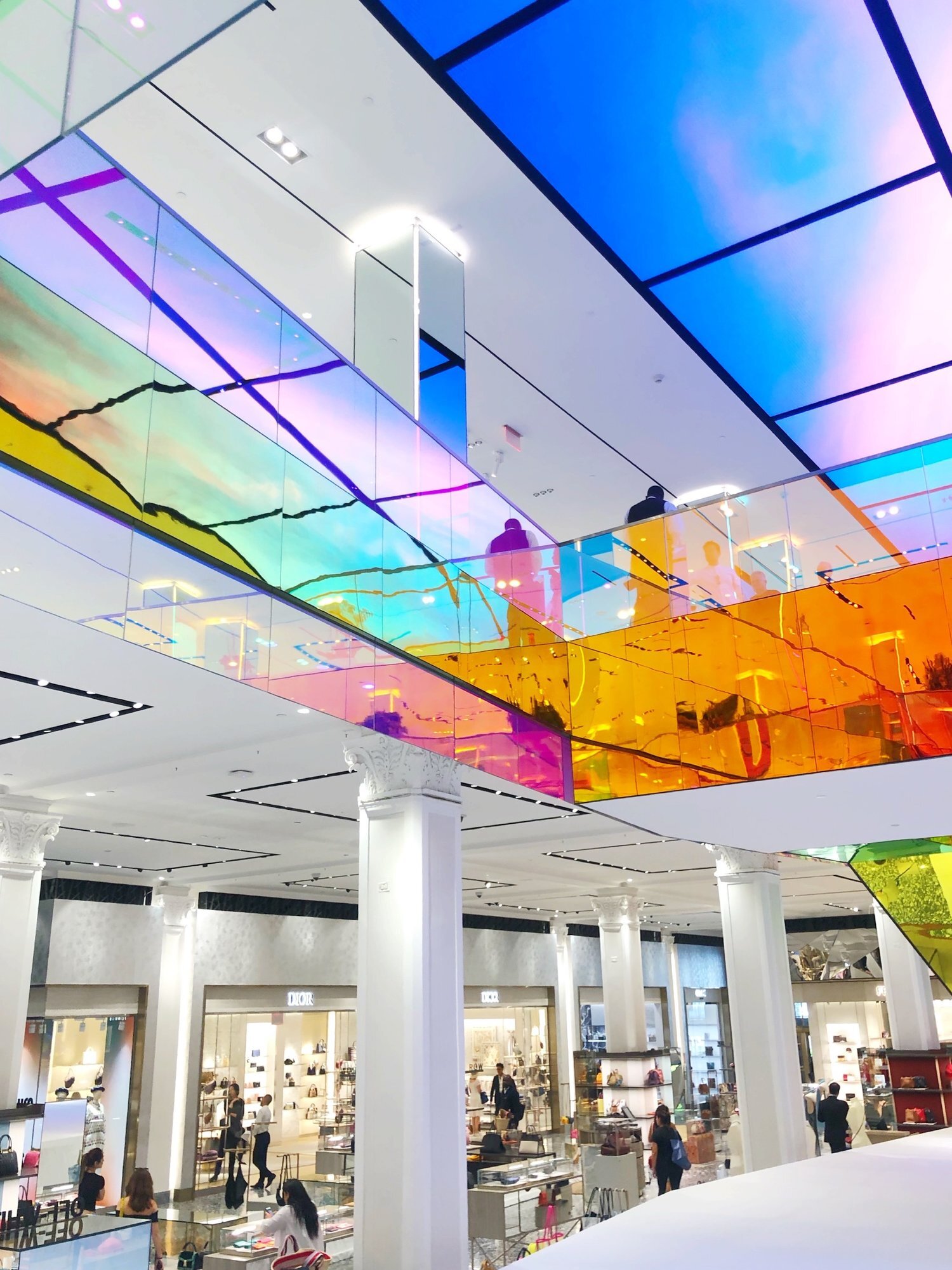 OMA adds iridescent glass escalator to New York's Saks Fifth Avenue