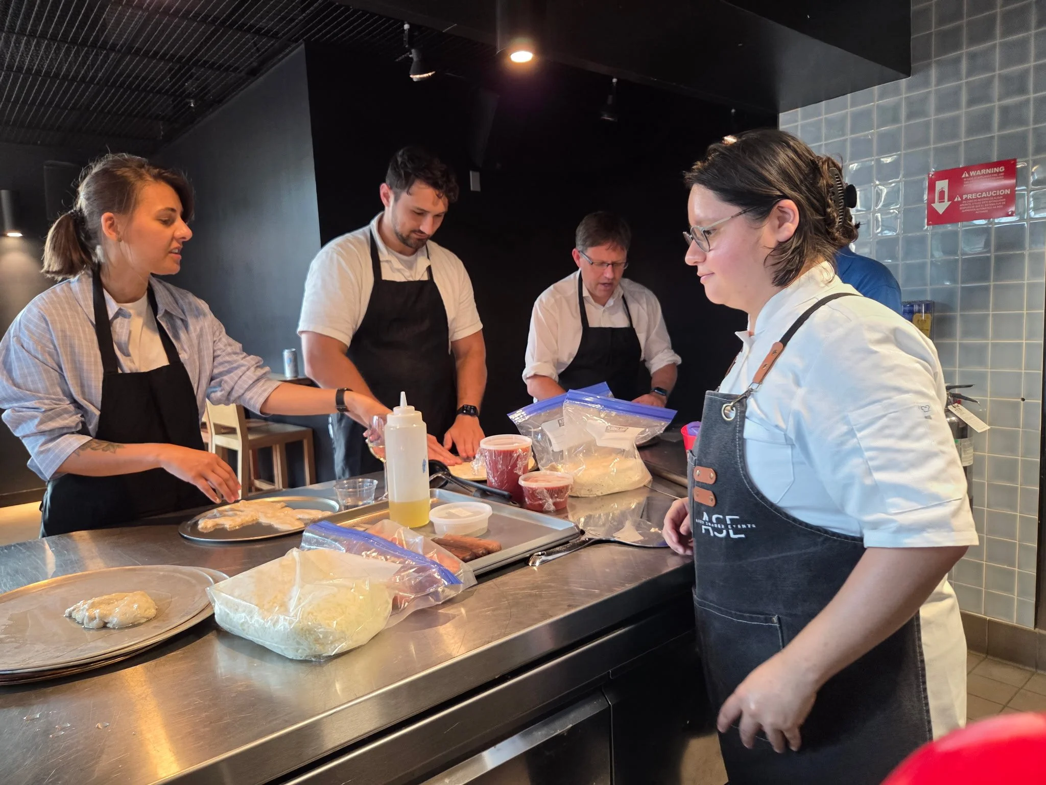 People cooking and preparing food together in a kitchen.