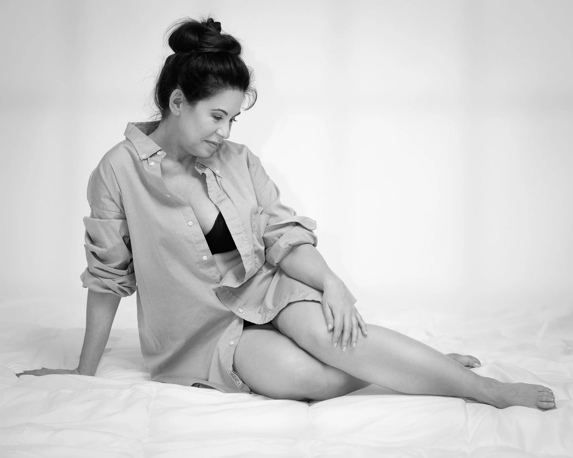 intimate boudoir portrait woman bed white shirt studio