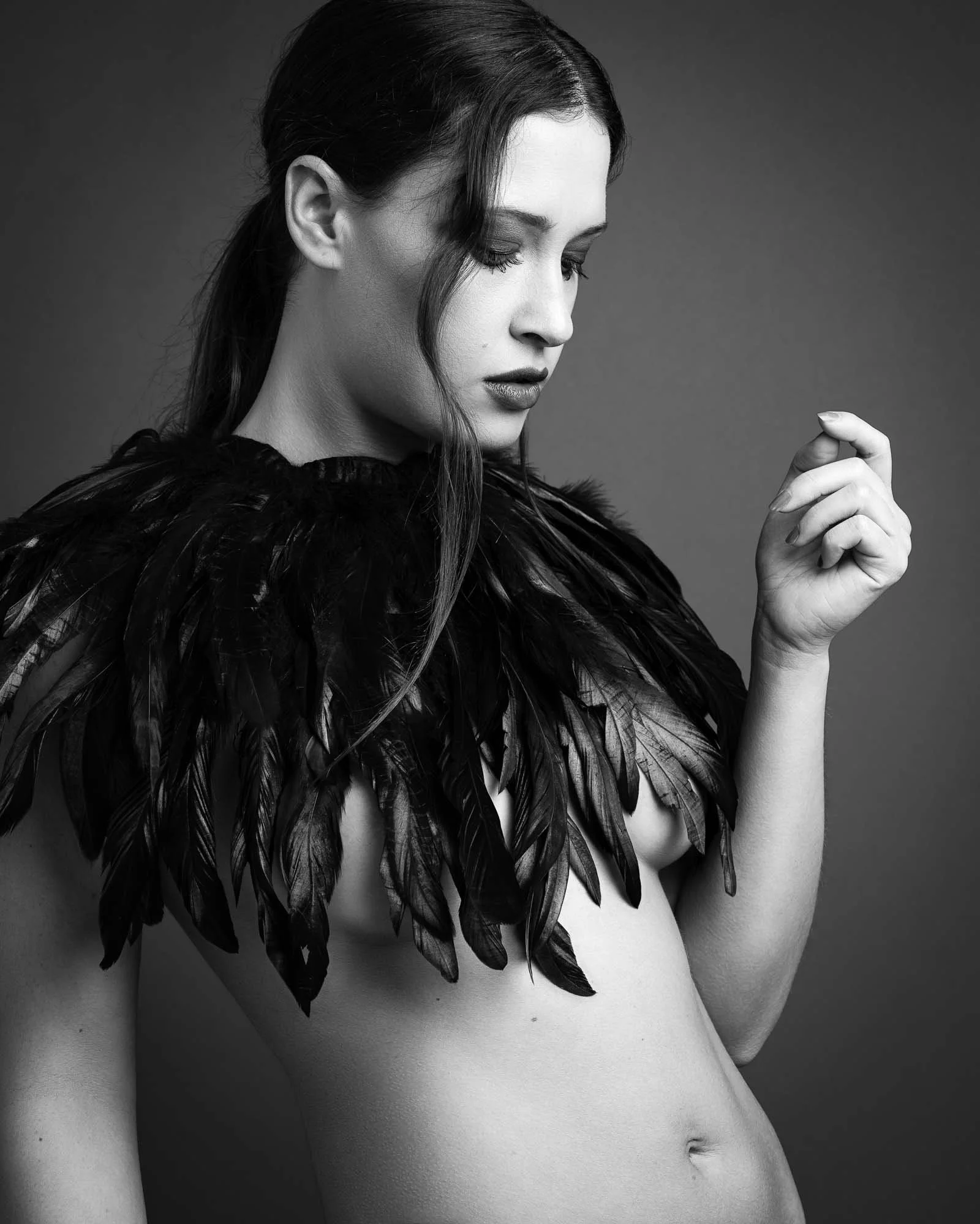 artistic boudoir photography woman feathers implied nude studio