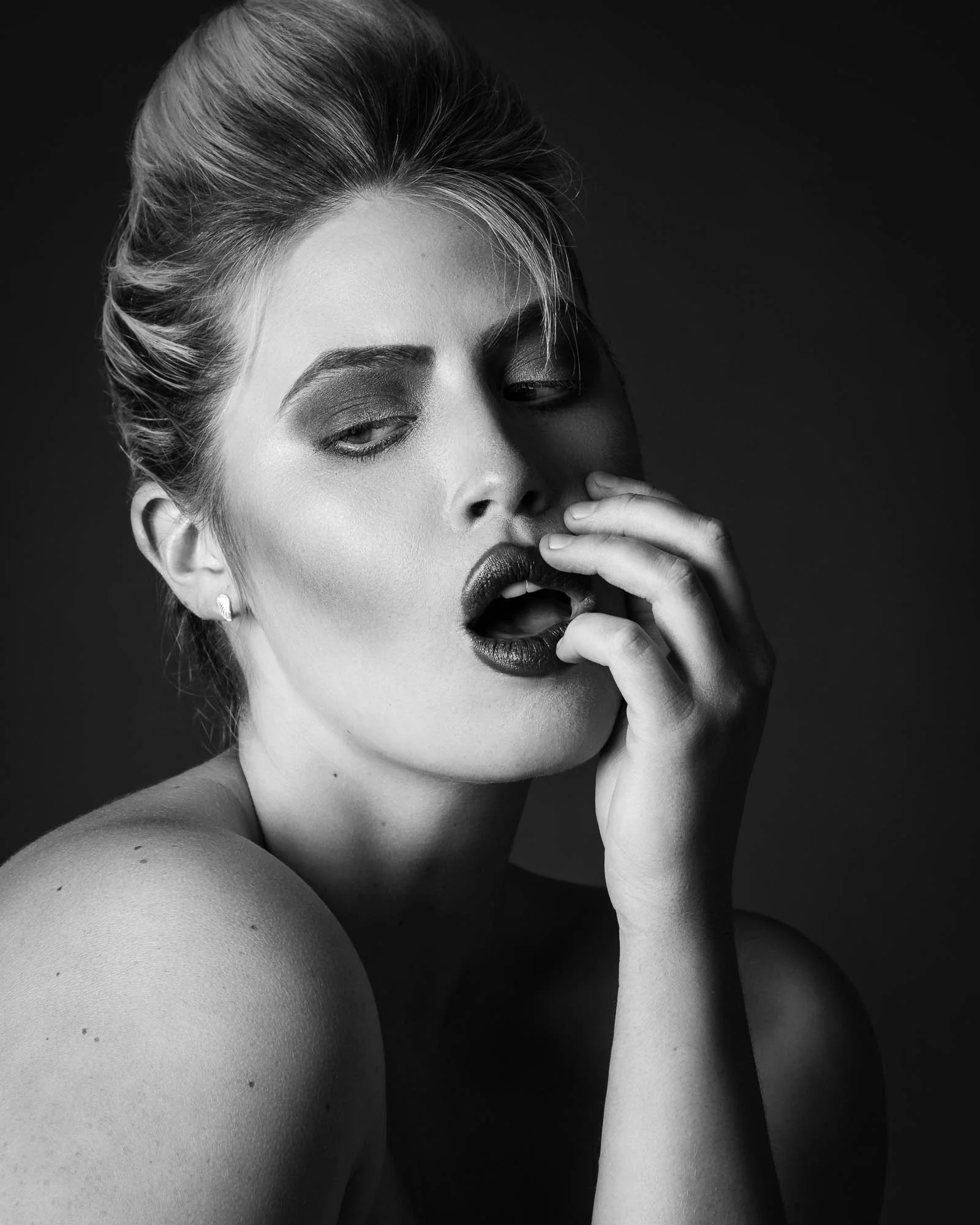 intimate boudoir portrait woman implied nude studio photography