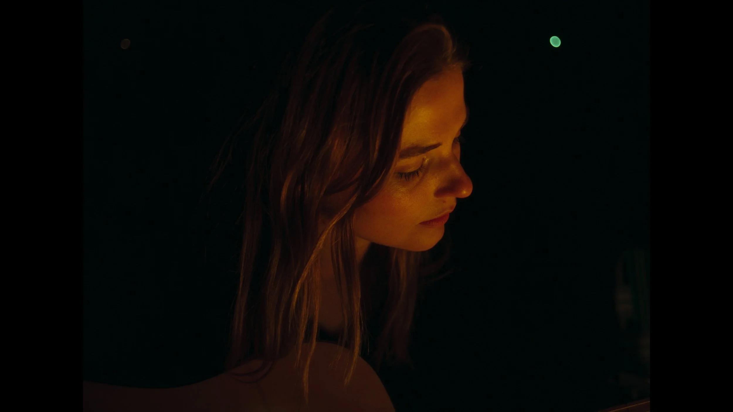 cinematic still frame from indie film, Openers, woman sits next to fire pit with guitar in her lap, glowing from the warm light of the fire