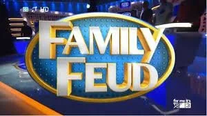 Family Feud television show logo with studio background.
