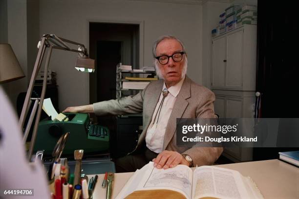 author-and-scientist-isaac-asimov-looking-at-a-reference-book.jpg