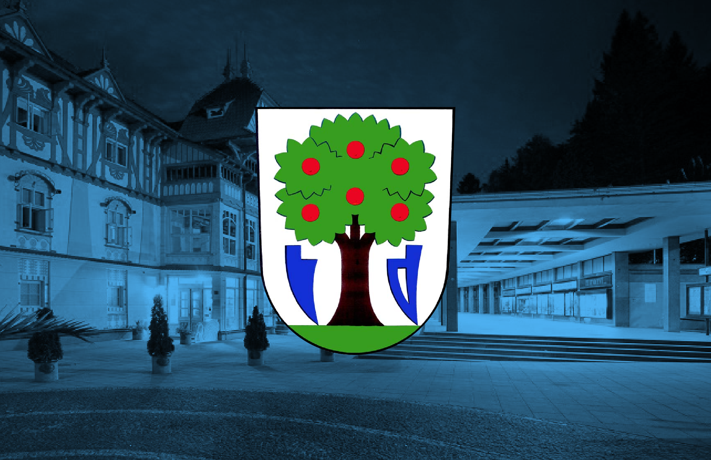 A coat of arms with a tree bearing red apples in front of a building with a blue overlay.