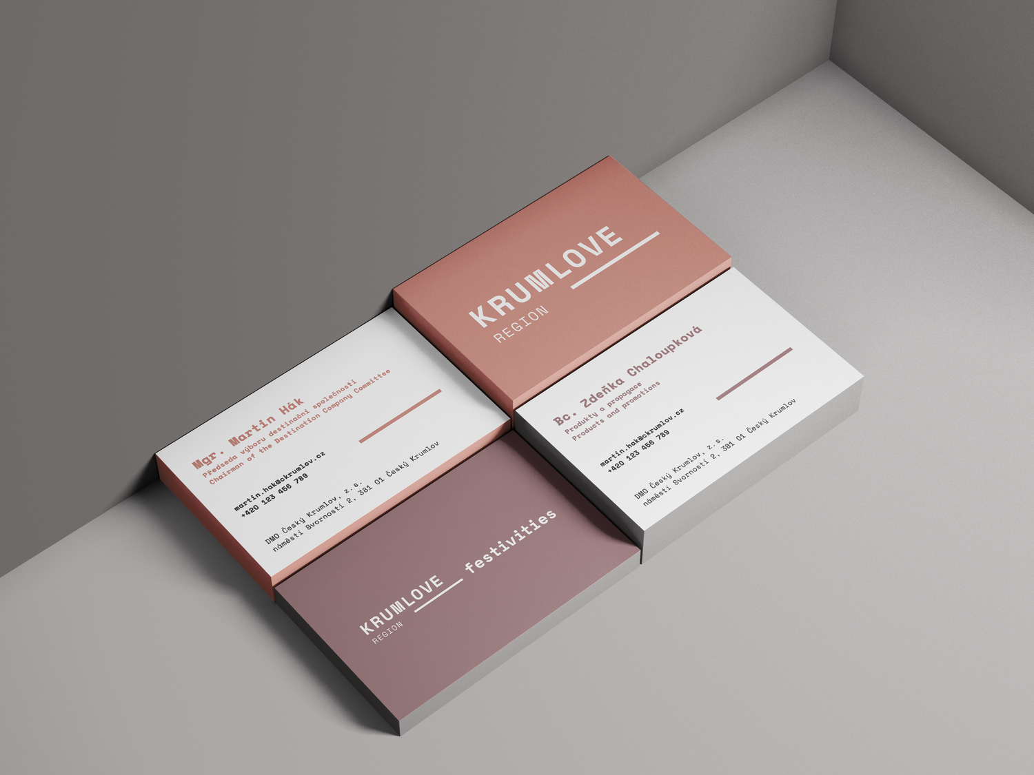 Business cards and flyers for KrumLove region, featuring names, titles, contact information, and promotional text, displayed on a light grey surface.