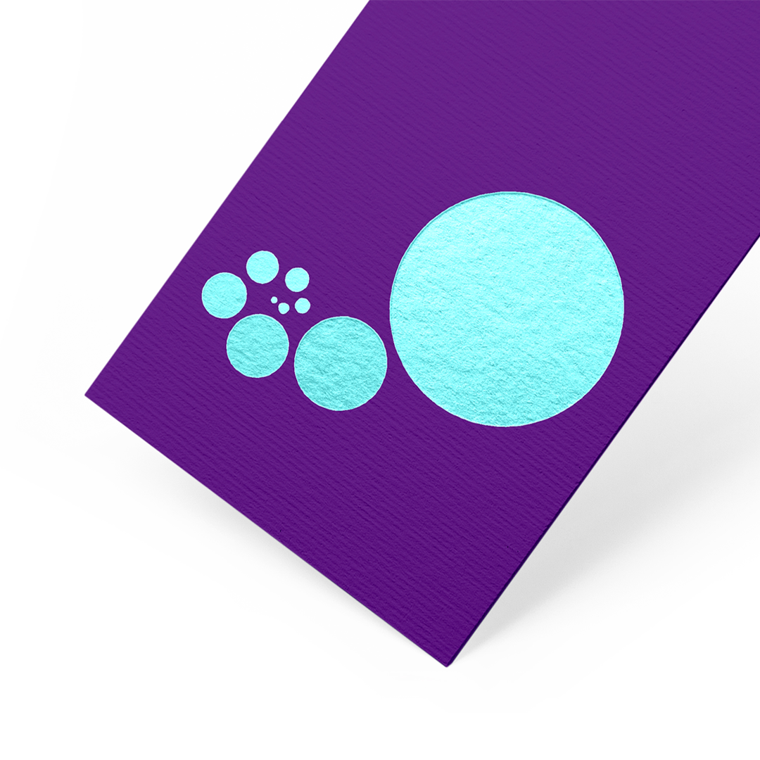 A purple bookmark with six light blue circles of various sizes arranged in a curved line.