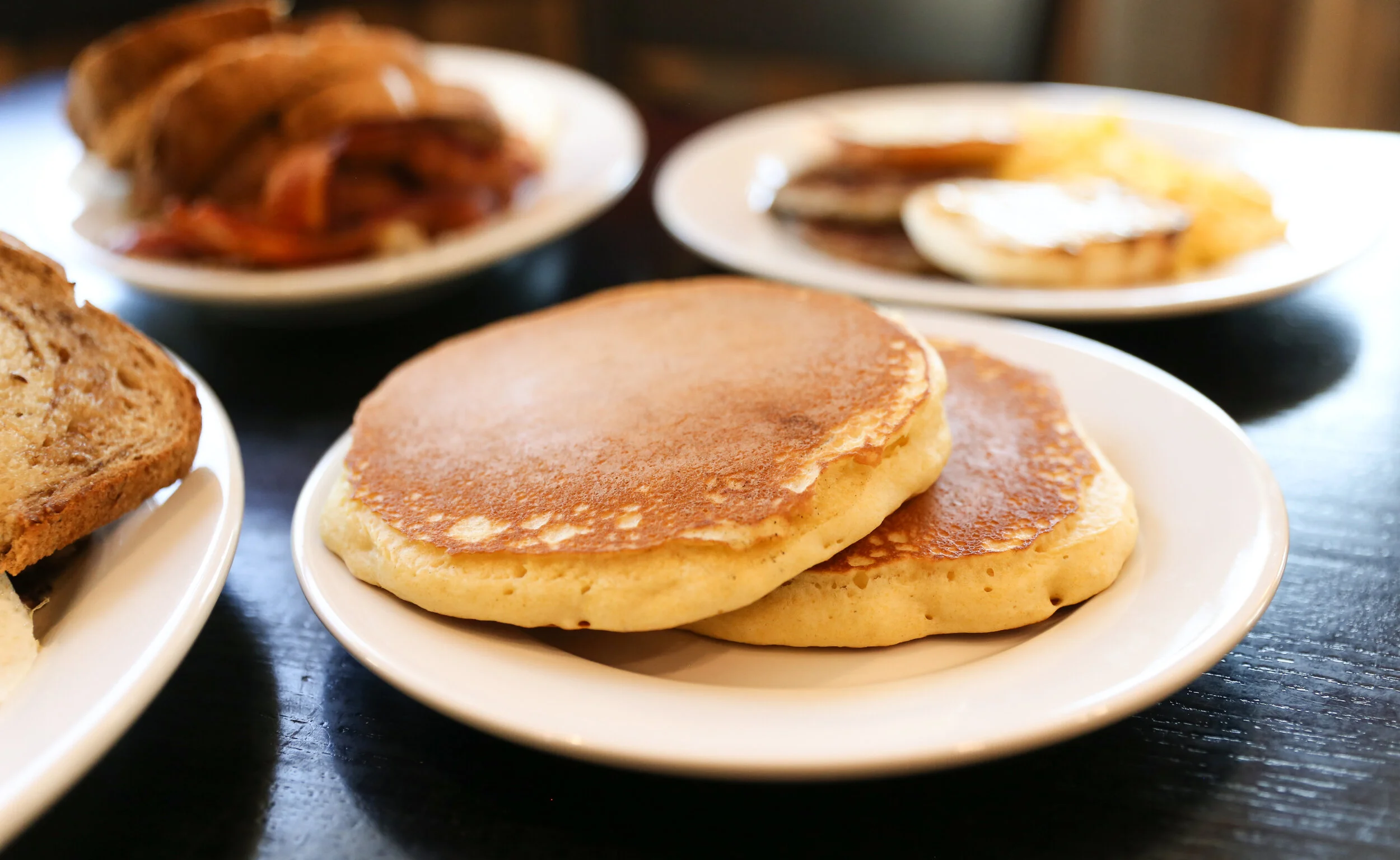 A patron reading a menu with a cup of tea