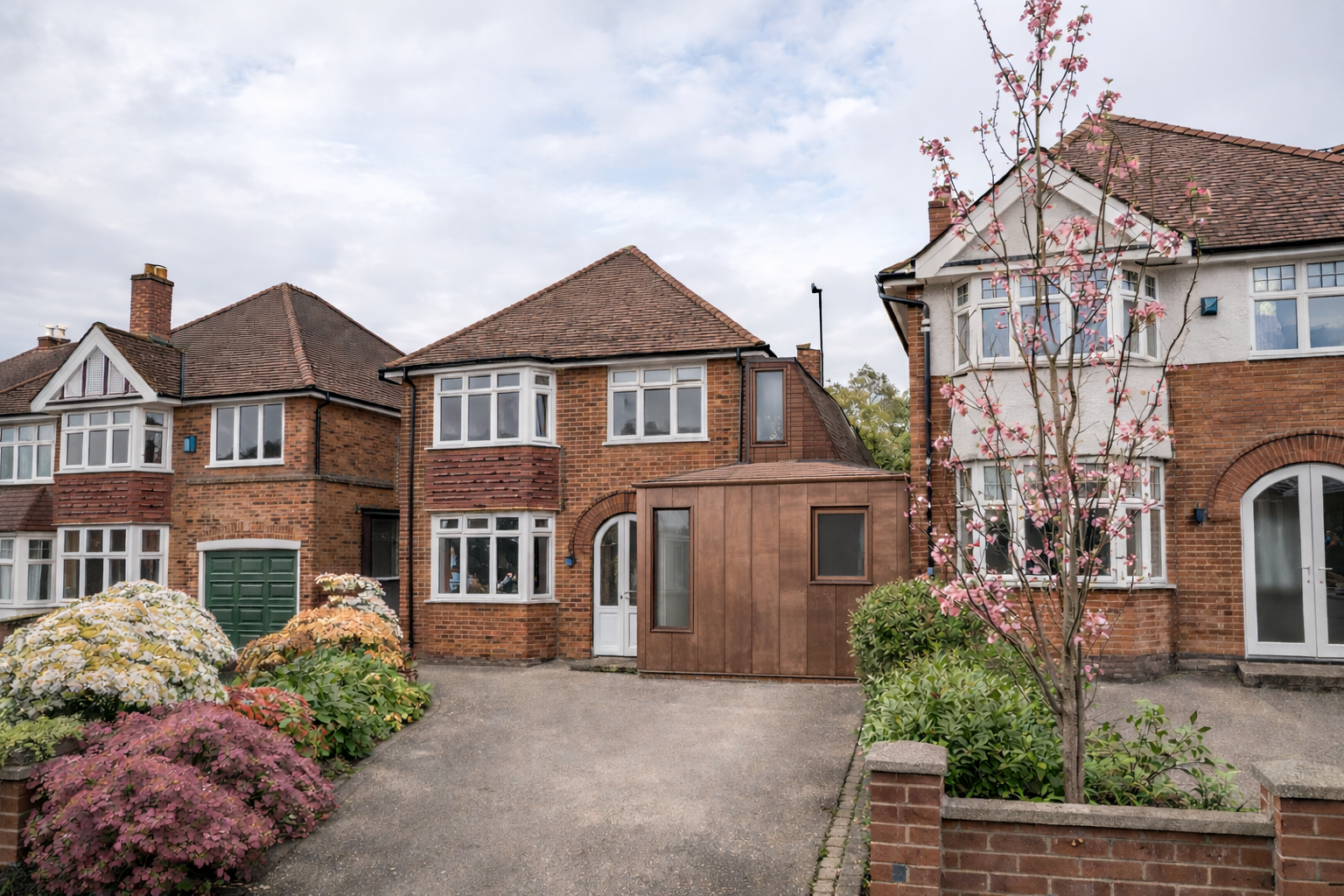 Copper-clad home extension to a traditional brick house in Moseley, Birmingham, designed as a subtle contemporary addition that complements the original architecture.