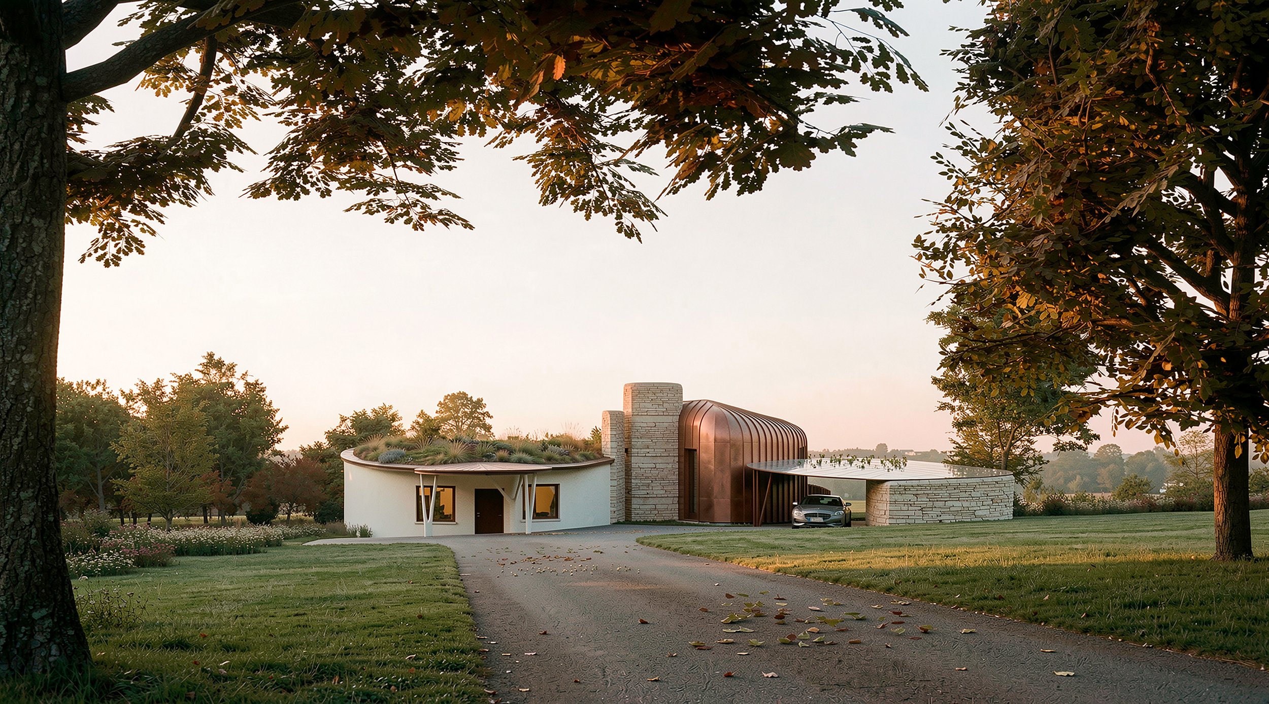 Contemporary unique homestay in the Malvern Hills, Worcestershire, with a standing-seam copper roof, stone walls and a green living roof, approached along a driveway through parkland at dusk.