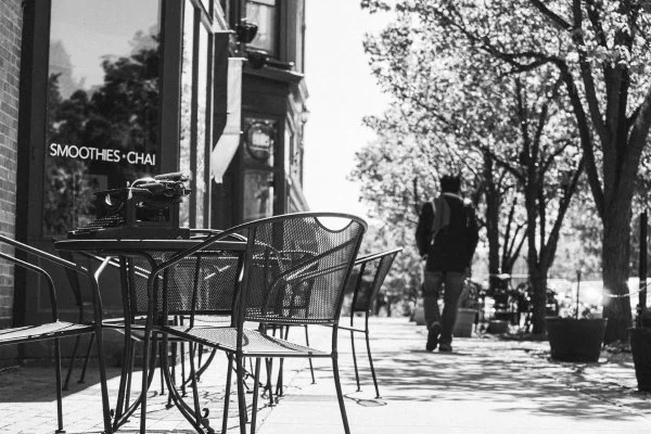The writer departs from a sidewalk cafe in Rochester, N.Y. (Photograph by James Bogue)