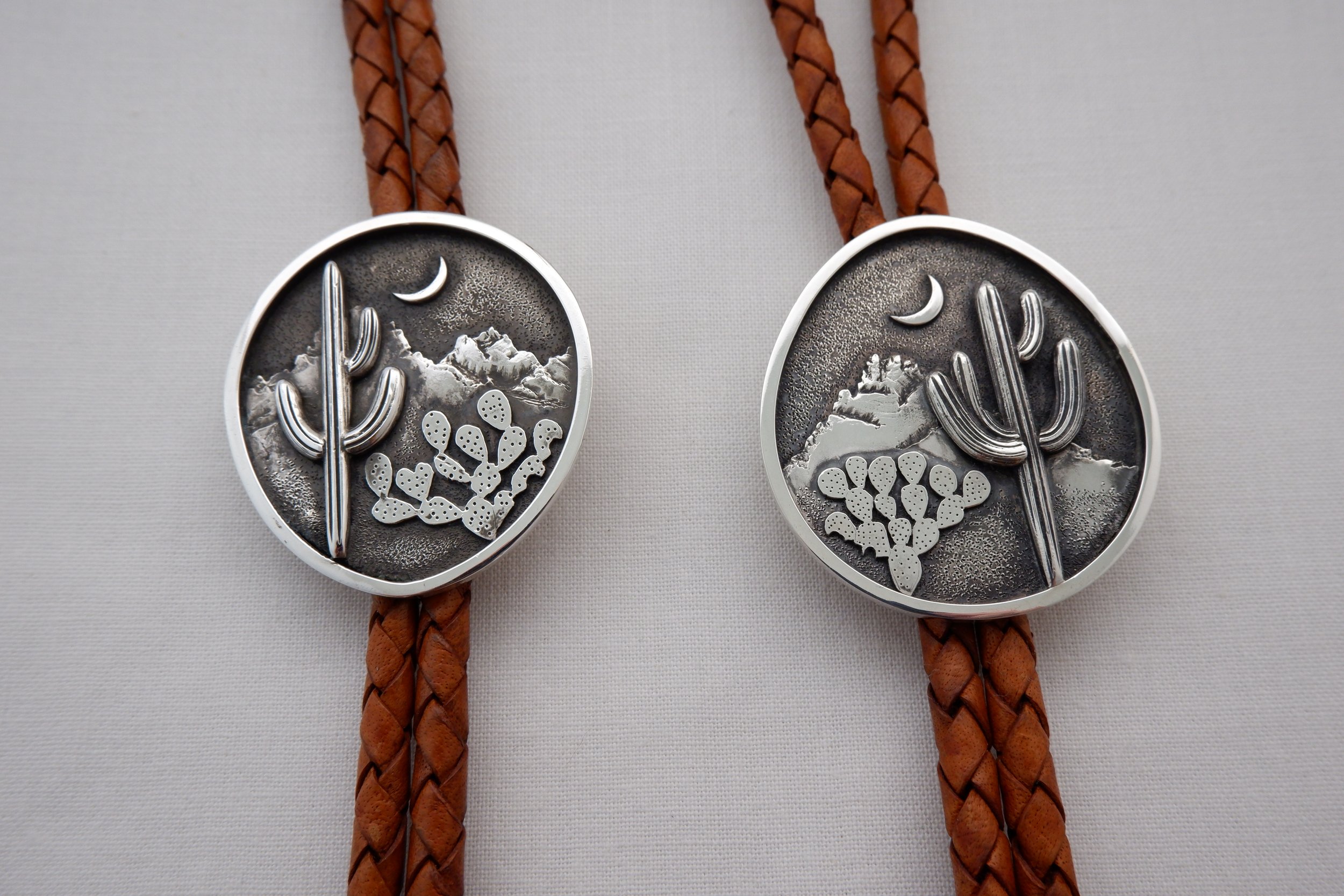 expert silversmith instructor Erik Nakai Buckley mountain landscape bolo ties.JPG