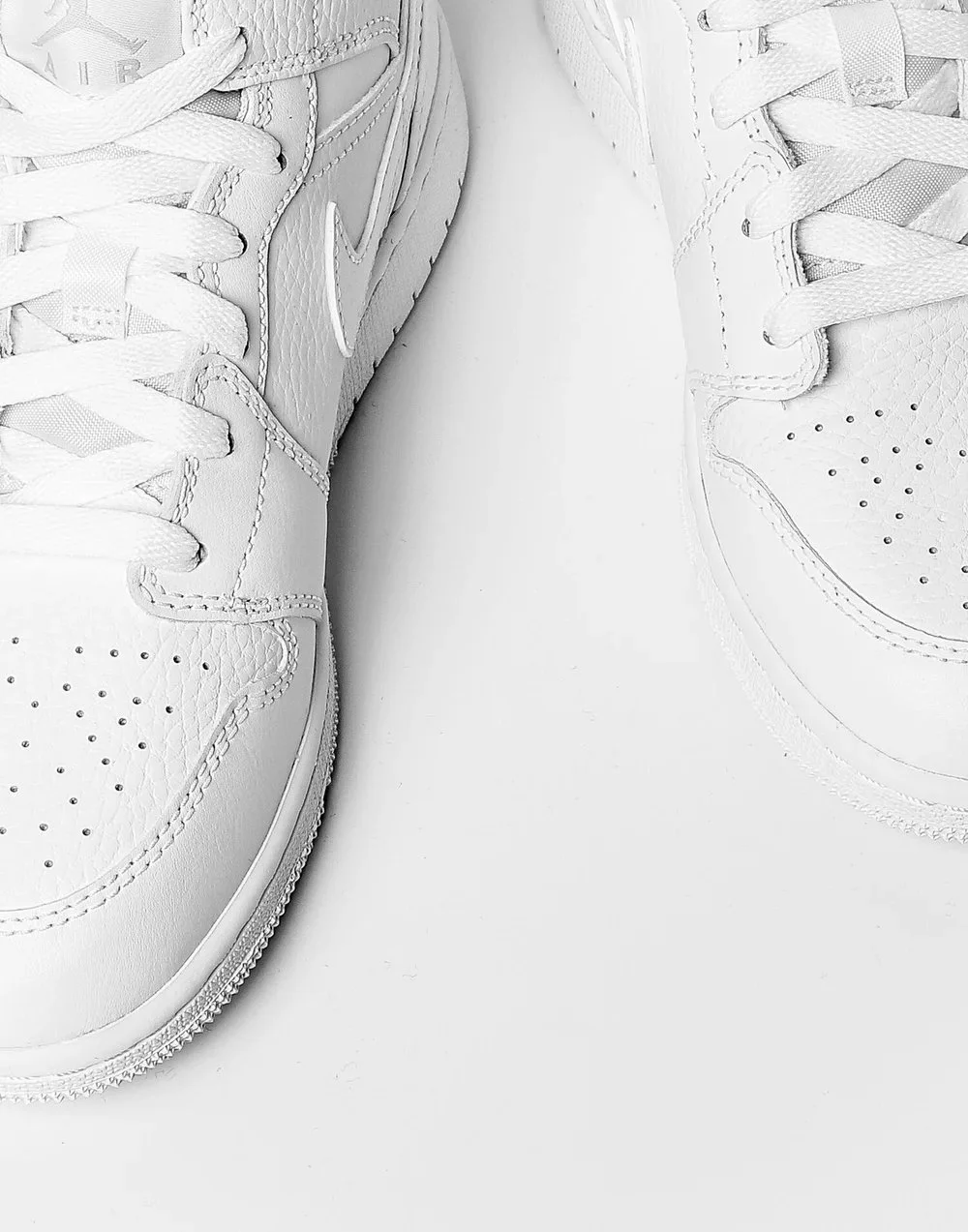 Close-up view of a pair of white sneakers.