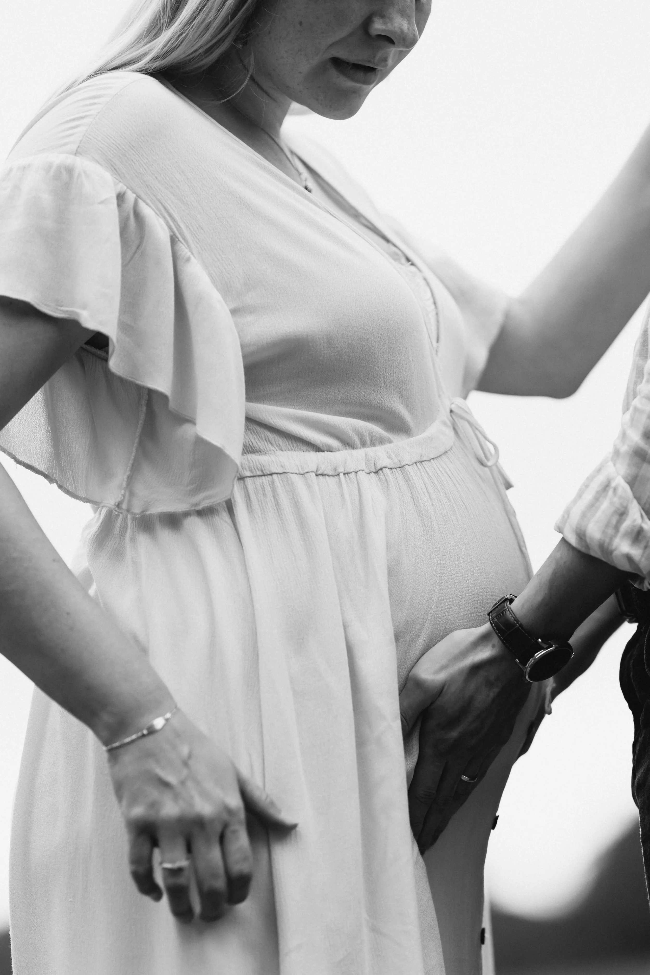 Elegant maternity editorial portrait in a white dress, profile close-up, by VdVisuals