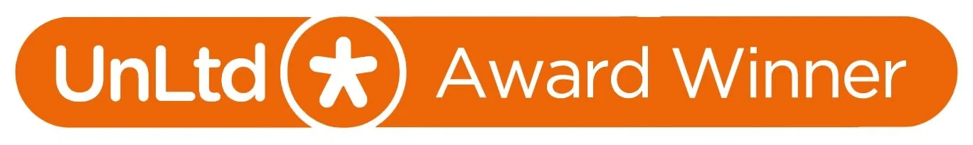 UnLtd Award Winner badge with an orange background, white text, and a white asterisk symbol in a circle