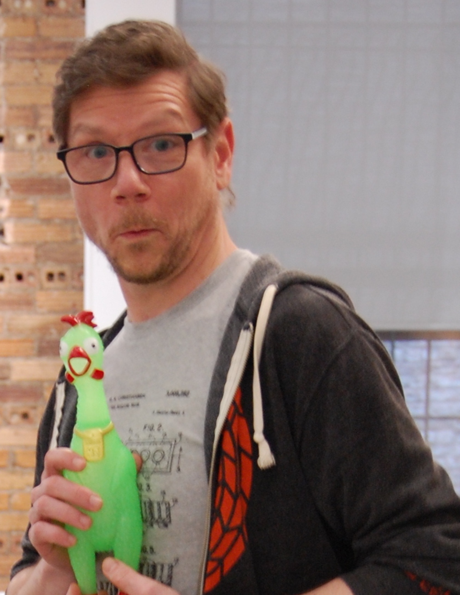 Brandon Wetzstein with Clarence the rubber chicken during a keynote speech. This playful presentation style makes business concepts about team dynamics more engaging and memorable