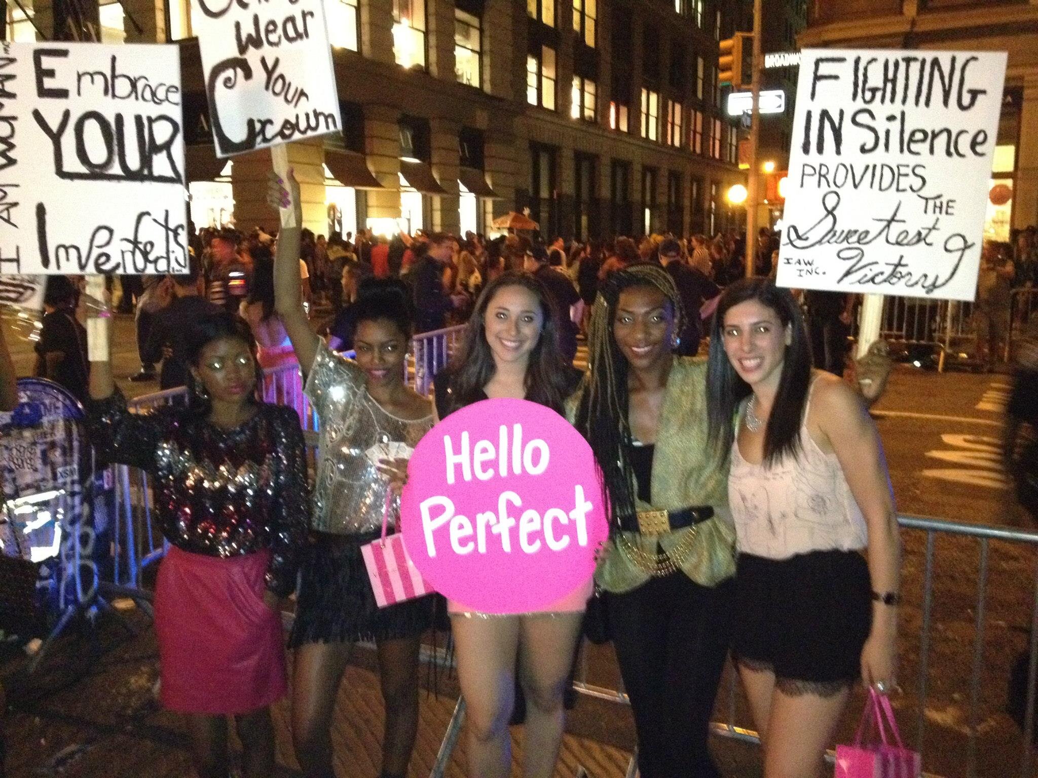 Ch 4: The Flexible Plan - Me and Angela on the busy NYC streets with the Hello Perfect sign for Fashion's Night Out.