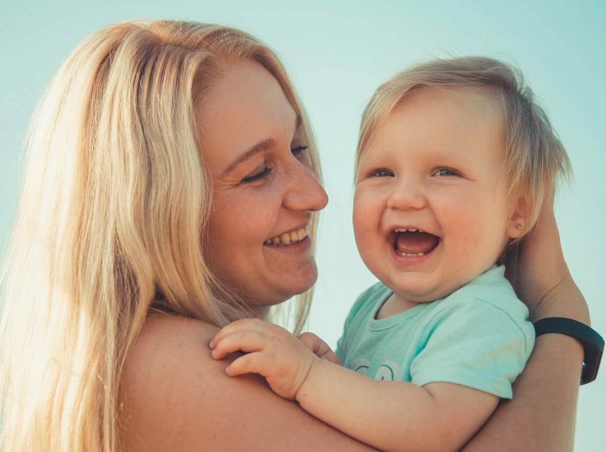 Indian Hill baby happily held by a trusted childcare provider as parents take time to rest and focus on other priorities