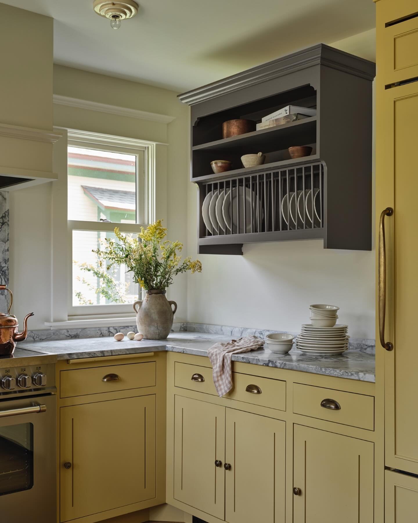 Design a kitchen but make it yellow 💛. Our clients came to us looking for a kitchen that was anything but the usual colors - after going through the paint deck a few times we landed on the sunniest shade of yellow paired with the muddiest purple and
