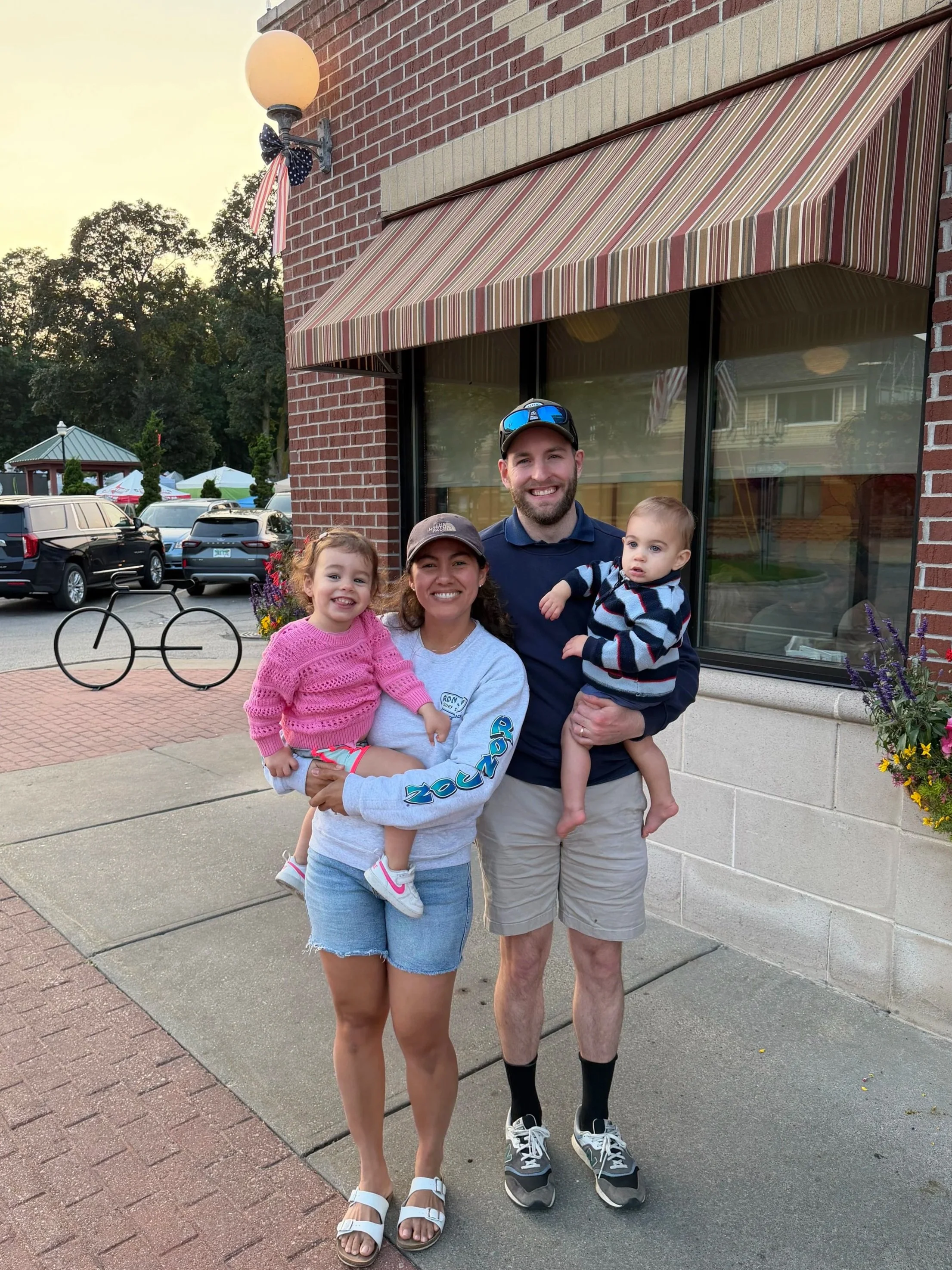 Dr. Luke Vroegindewey and his family in front of House of Flavors in Ludington, MI
