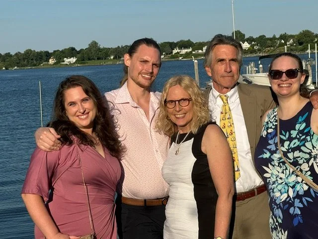 Mary Wilson poses with her family in front of a lake.