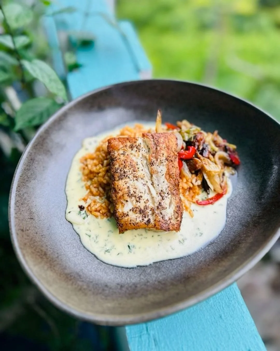 Wild caught mahi over chipotle rice, with a garlic cream sauce and warm cabbage slaw. Monday is for Mahi!