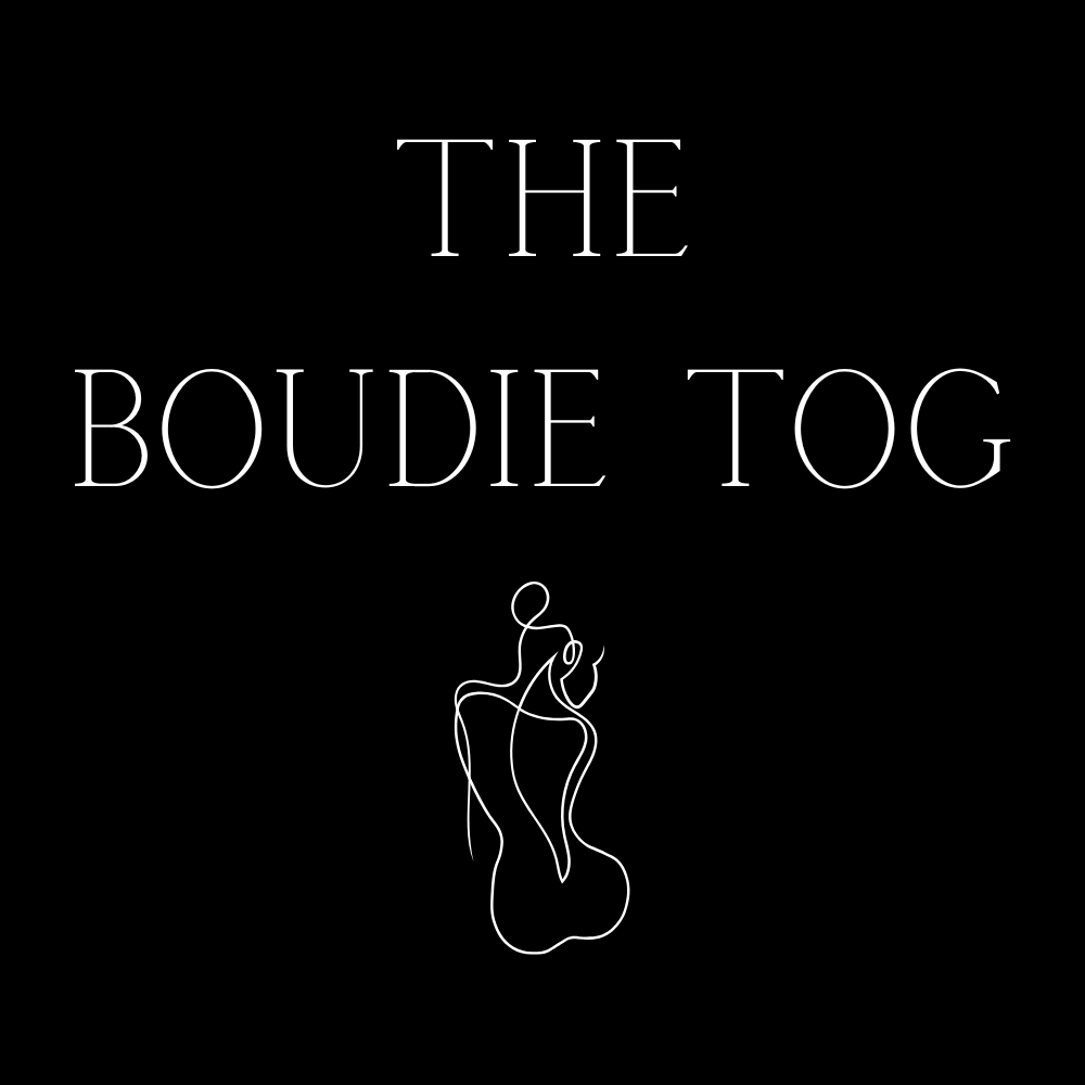 Black background with white text that reads 'The Boudie Tog' and a simple white line drawing of a woman wearing a bikini, with a ponytail, holding a surfboard.
