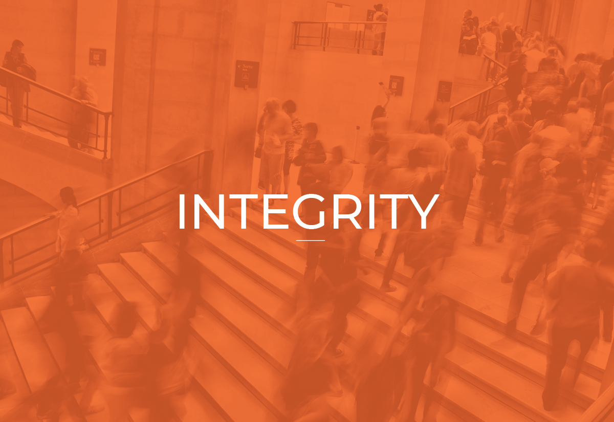 People walking and standing in a busy indoor space with stairs and railings, some waiting in line or talking, overlaid with the word 'INTEGRITY'.