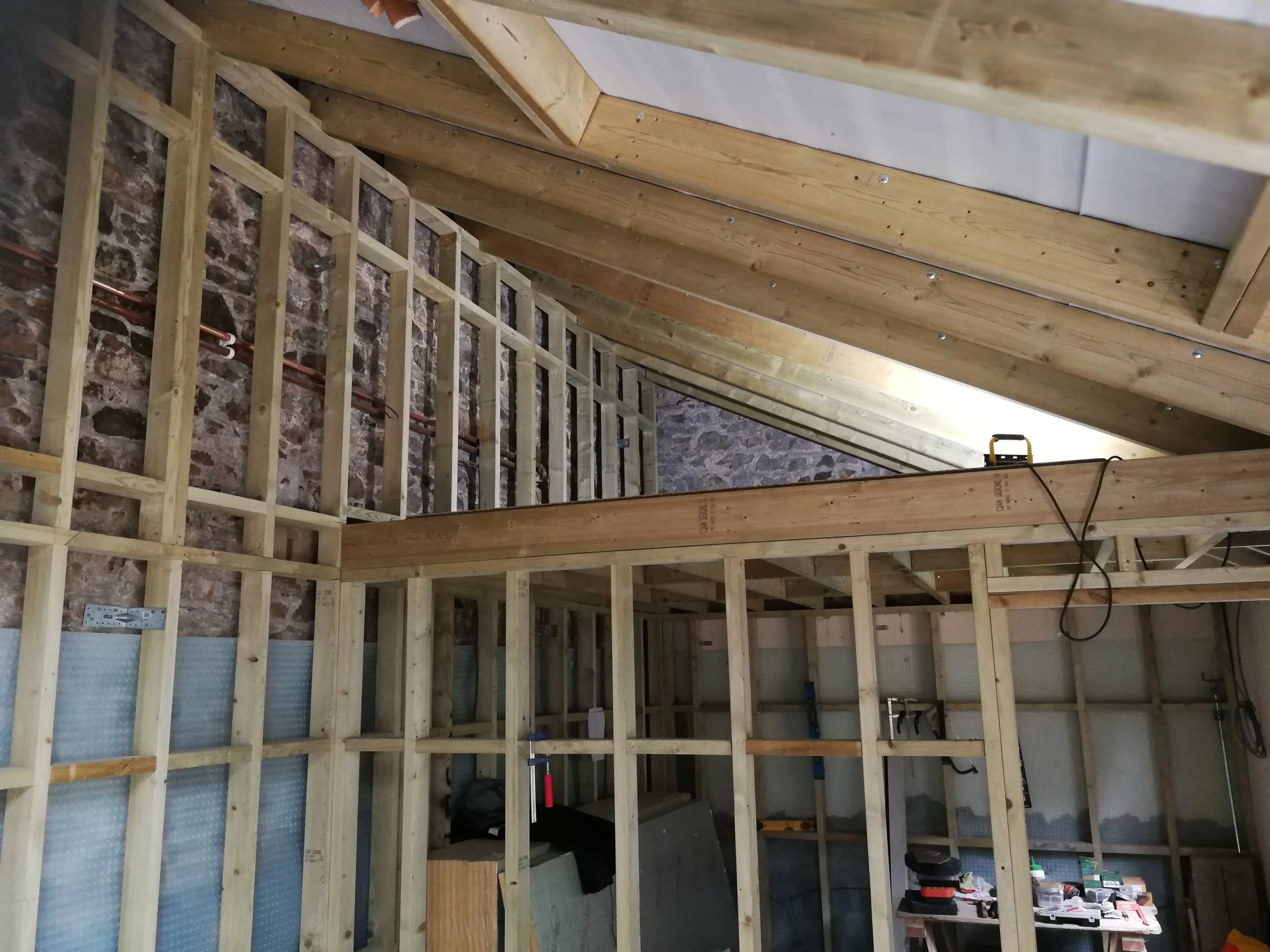 New stud work, extra rafters, mezzanine above.