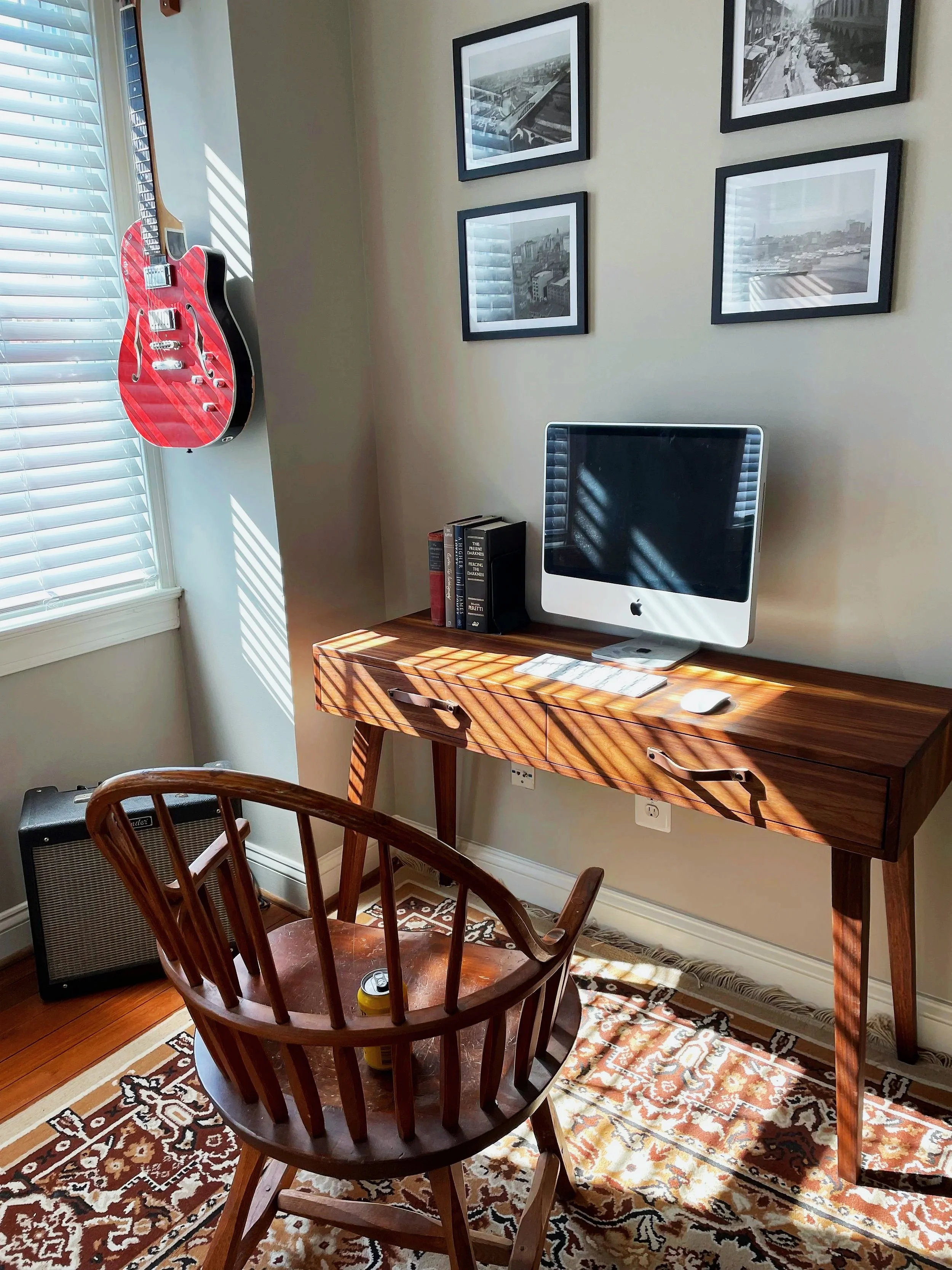 Custom walnut writing desk with tapered legs and leather drawer pulls, in a Baltimore home office.
