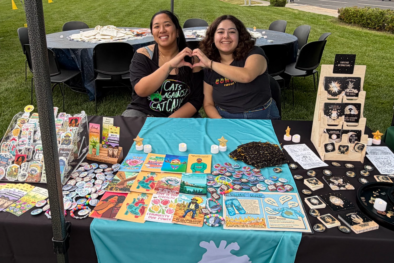 Two RVCC staff members tabling with consent, healthy relationships, bystander intervention, and survivor support materials.