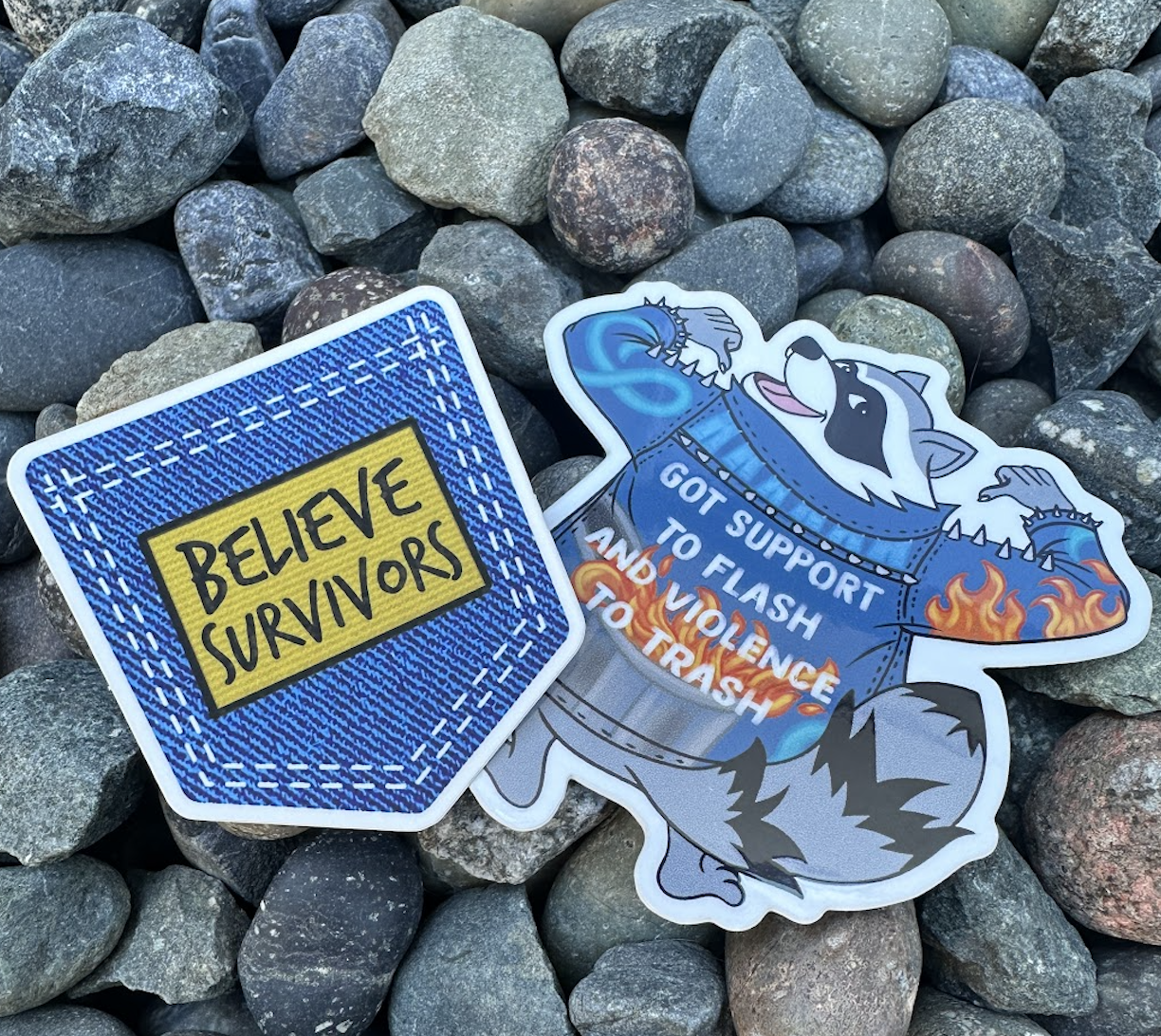two SAAM survivor support and denim day themed stickers: One is a patch that says believe survivors. The other is a raccoon wearing a denim jacket with the words, "Got support to flash and violence to trash".