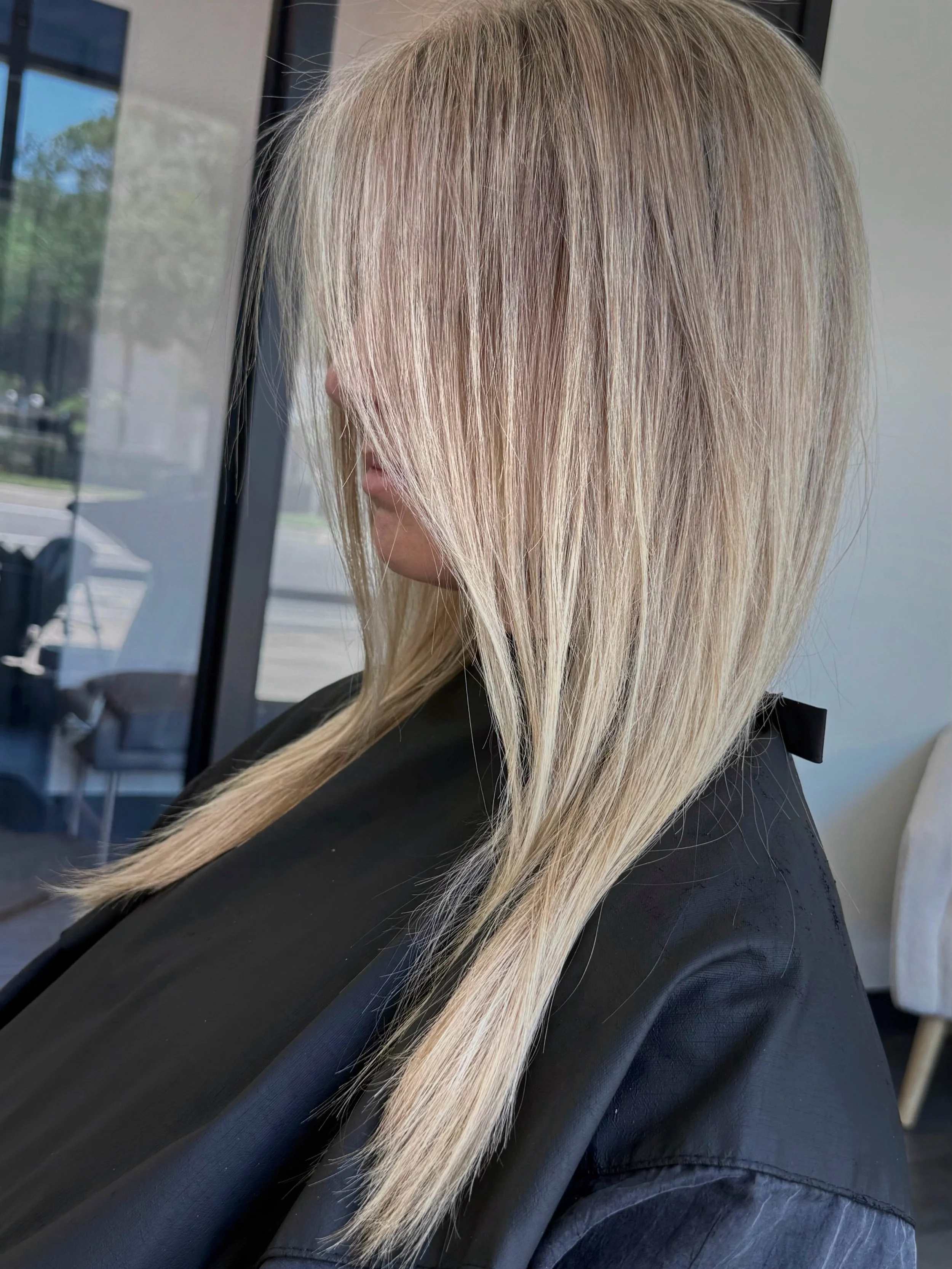 She likes her blonde on the cooler side but still bright and wanted to go a bit more dimensional near the root to create a softer transition line when her natural color grows back in. 

Highlights and lowlights create the blend. No need for a root sm