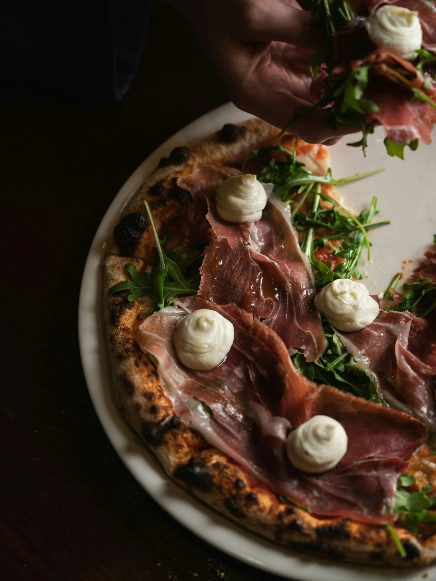 A pizza so delicious, it didn't survive the photoshoot.
Our prosciutto pizza is loaded with tomato, Fior di Latte, rocket and lemon ricotta, and it's very photogenic 📸