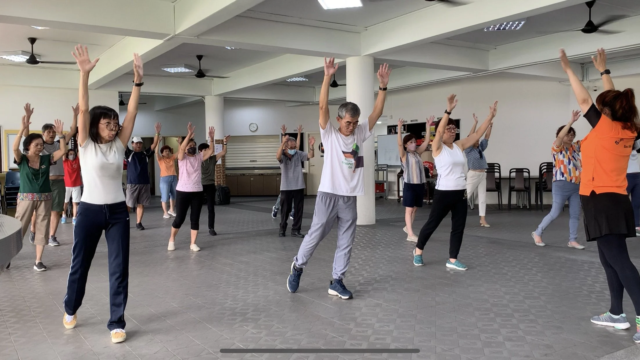 WSCS exercise with raised arms at Aldersgate Chapel social hall 2205x1242.JPG