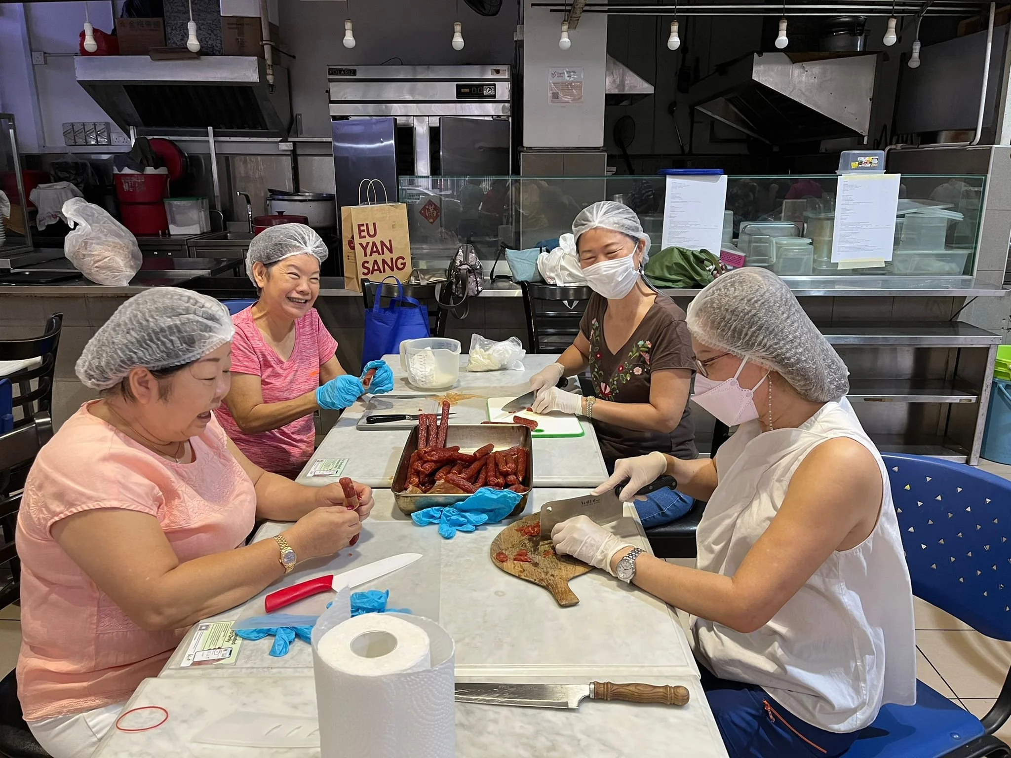 WSCS four women preparing Chinese sausages at a cafeteria 2048x1536.JPG