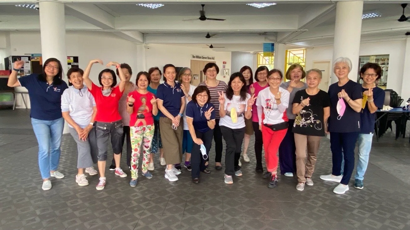 WSCS group photo posing at Aldersgate Chapel social hall 1306x735.JPG